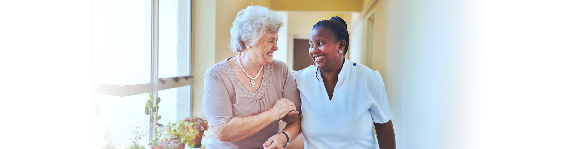 senior woman ang caregiver smiling